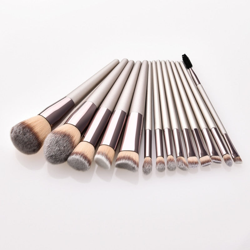 Set of makeup brushes with black and silver handles on a white background