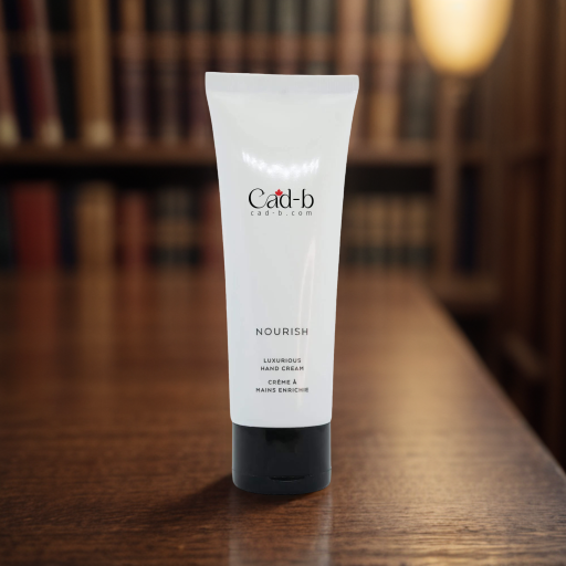 Tube of Cadr-b hand cream on a wooden surface with a blurred bookshelf background