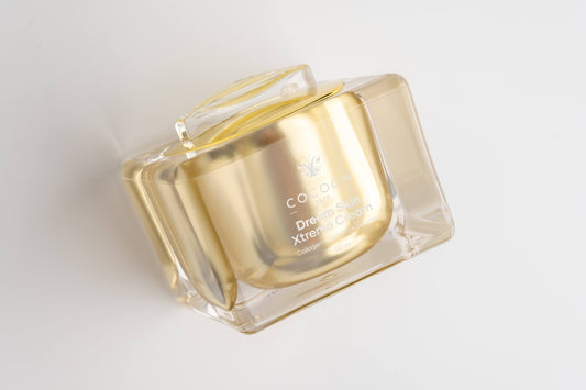 Gold container with clear lid on a white background