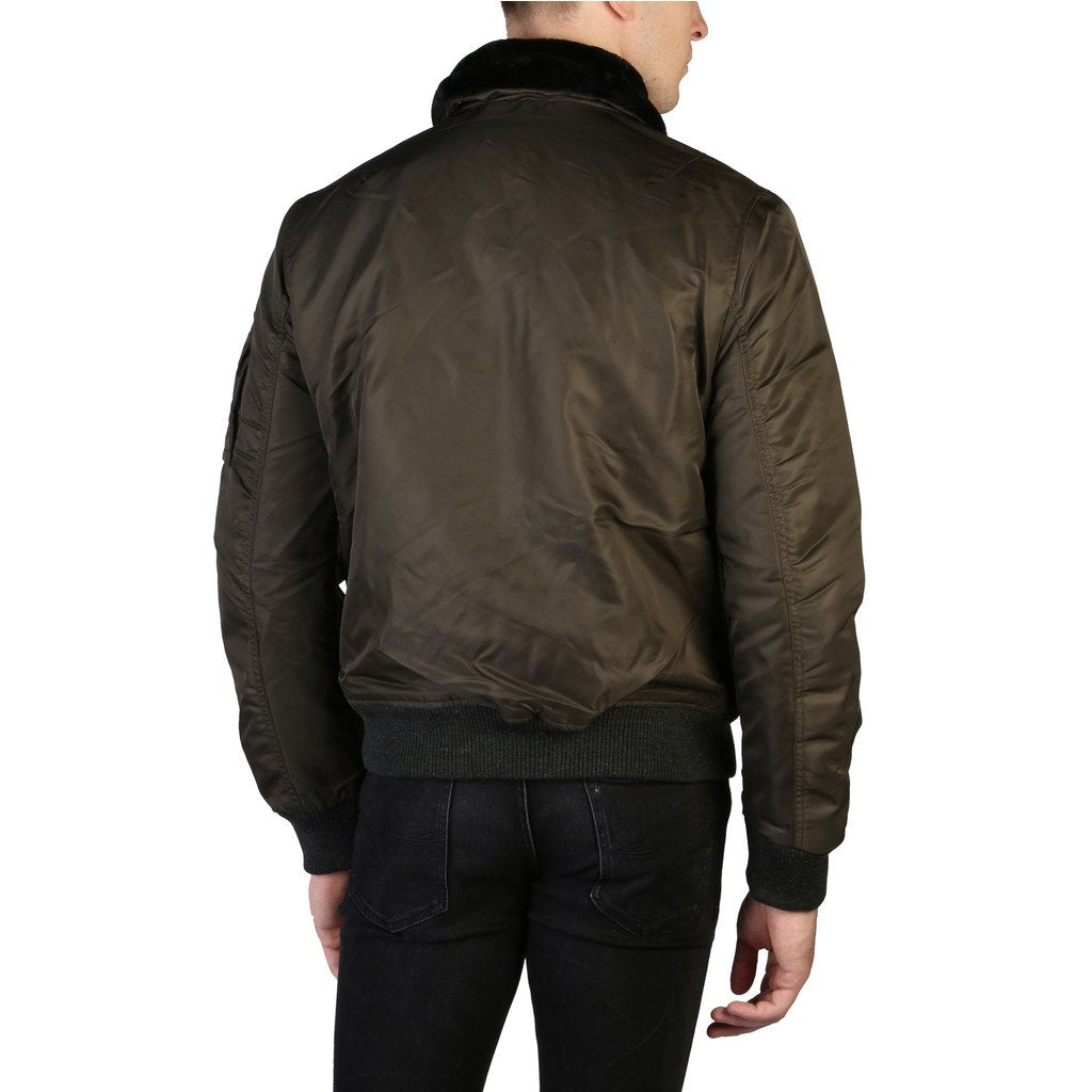 Man wearing a dark green bomber jacket on a white background