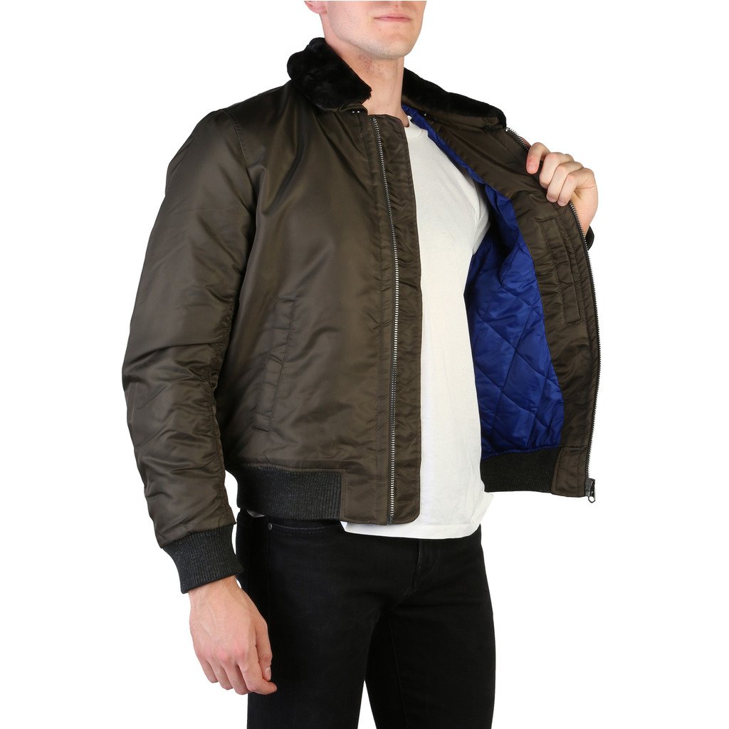 Person wearing a dark brown bomber jacket with blue lining on a white background